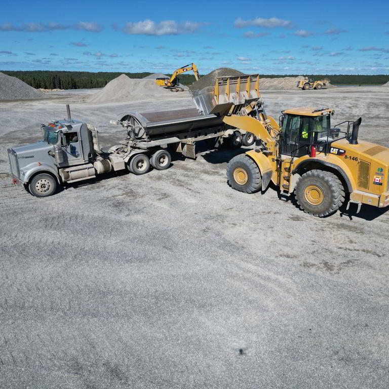 Wheel loader unloading into truck
